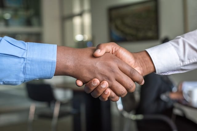 A firm handshake between two people