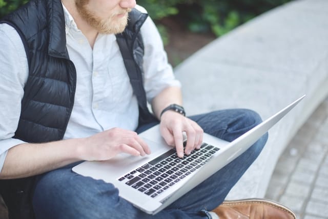 A man applying for a $200 payday loan on his laptop at home